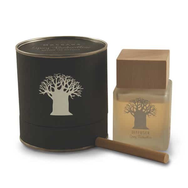 Elegant 120ml Sandalwood reed diffuser with a clear glass bottle and a rich, natural wooden stopper. The reeds are diffusing a warm, creamy, and sophisticated aroma suitable for home relaxation.