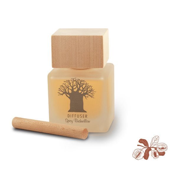 Close-up of a 120ml South African Spicy Bushwillow reed diffuser. The clear glass bottle features a natural wooden stopper and is often displayed with rattan reeds on a warm, earthy background.